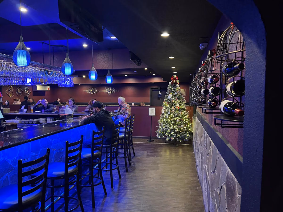 A view inside Mido Sushi with a blue lit counter and dining area